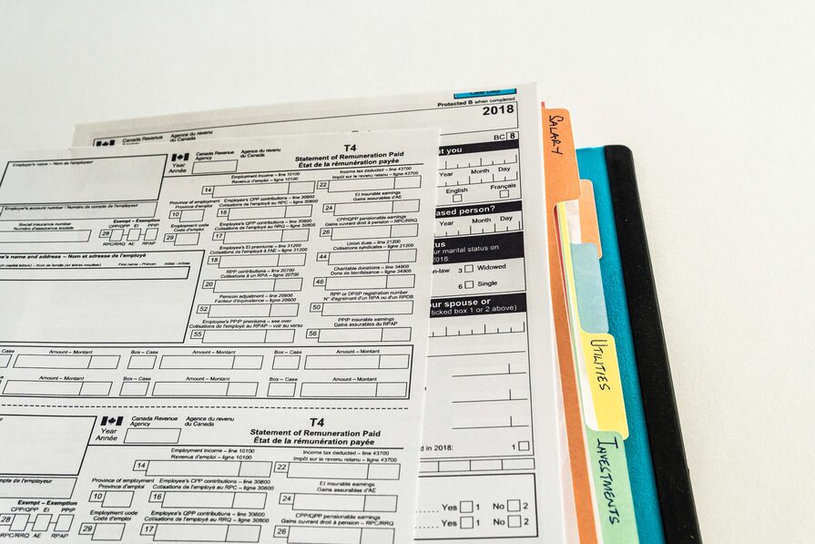 A pile of T4s on top of other business documents