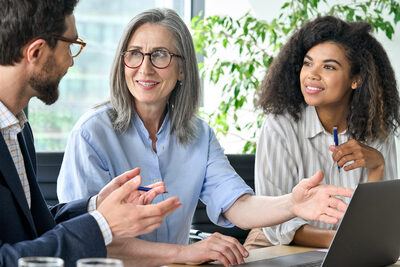 business managers discuss computer report