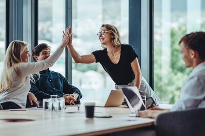 business team members exchange high 5