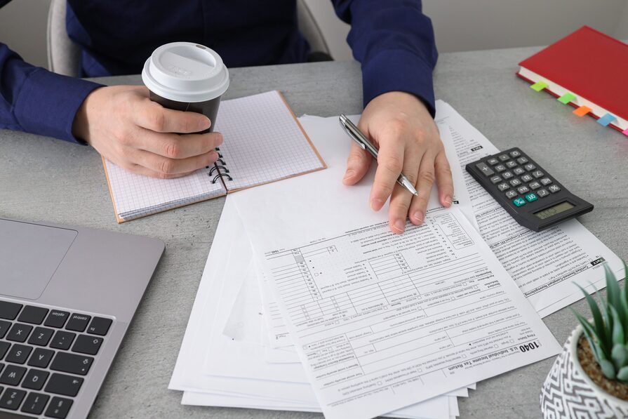 business-man-prepares-taxes-with-coffee