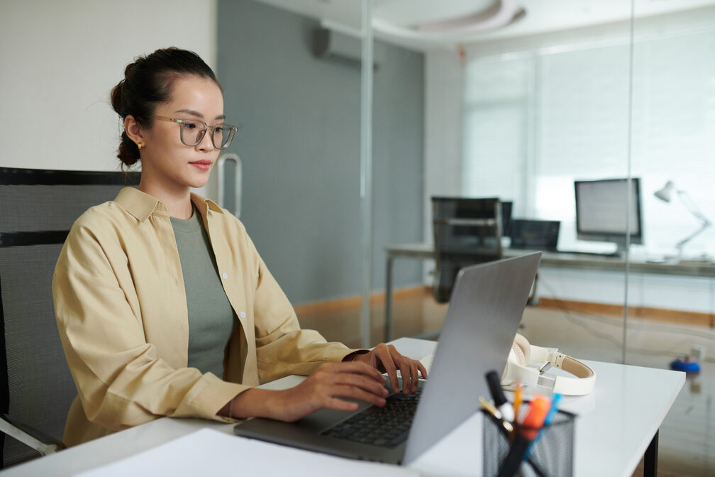 A young entrepreneur plans her business using her laptop