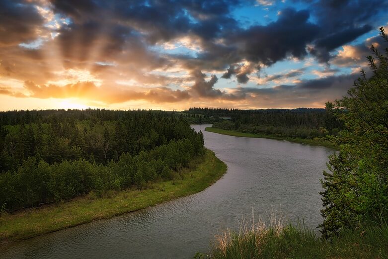 sun sets over the meandering Red Deer River