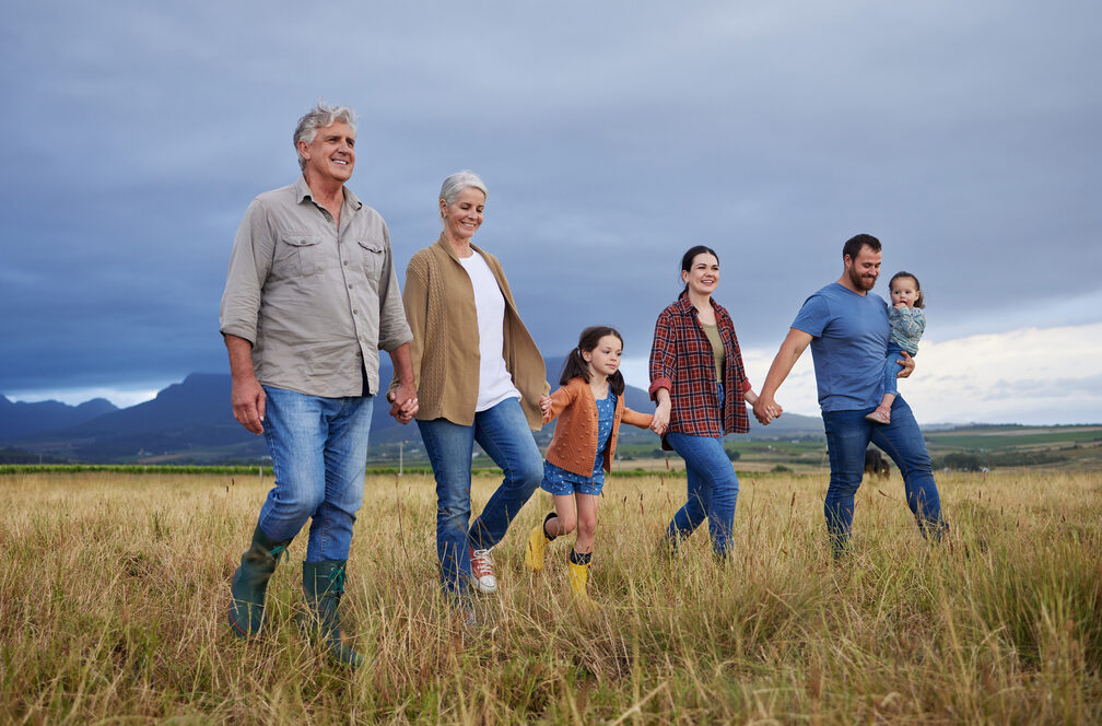 Three generations of a farm family stroll through their field