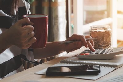Old-fashioned tax preparation with a calculator and lots of coffee